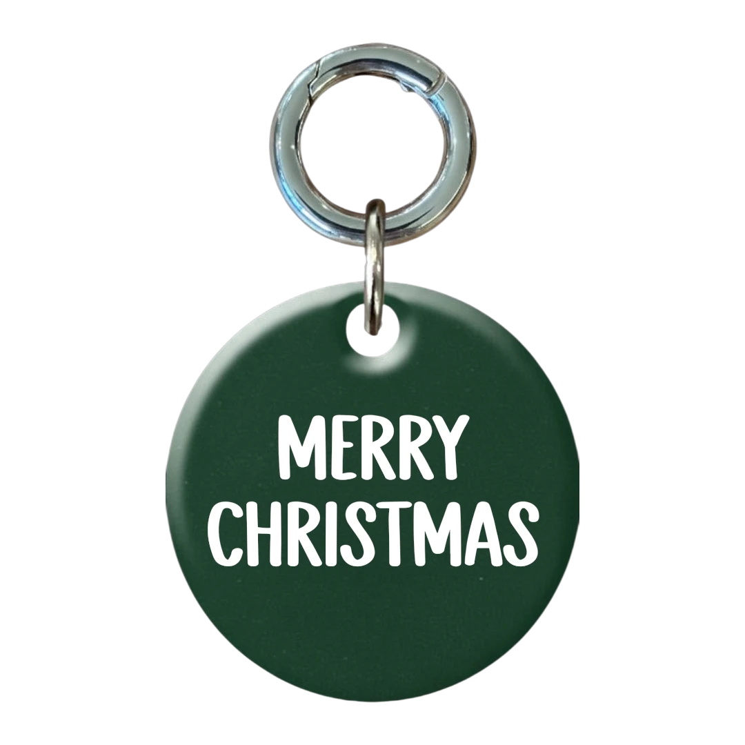 Green round tag with 'Merry Christmas' text on a white background