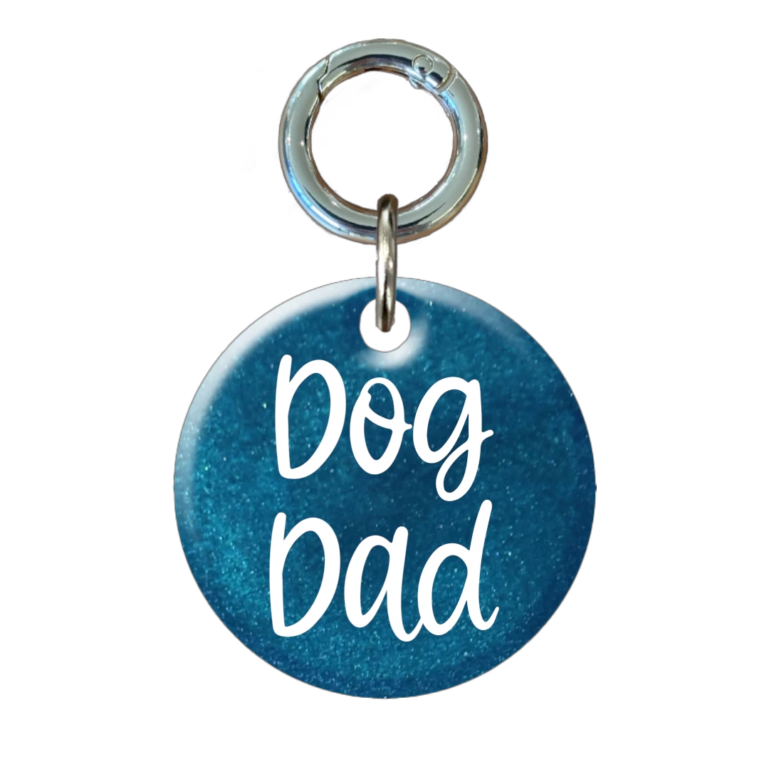 Blue pet tag with 'Dog Dad' text on a white background