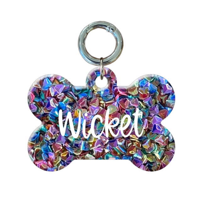 Colorful bone-shaped pet tag with 'Wicket'  on a white background